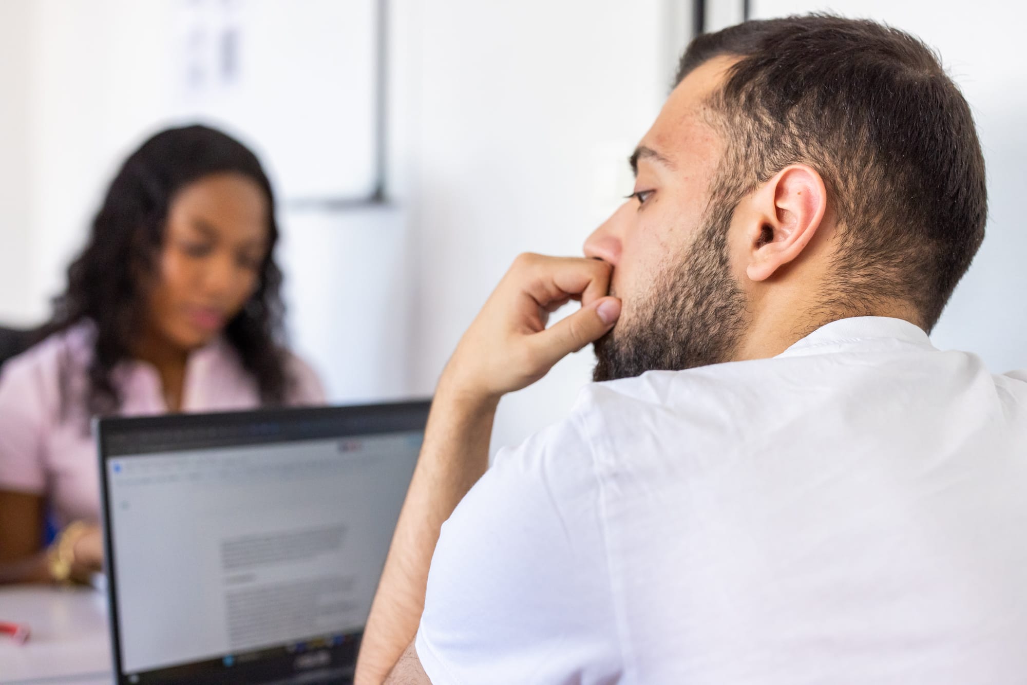 Étudiant réfléchissant devant son ordinateur